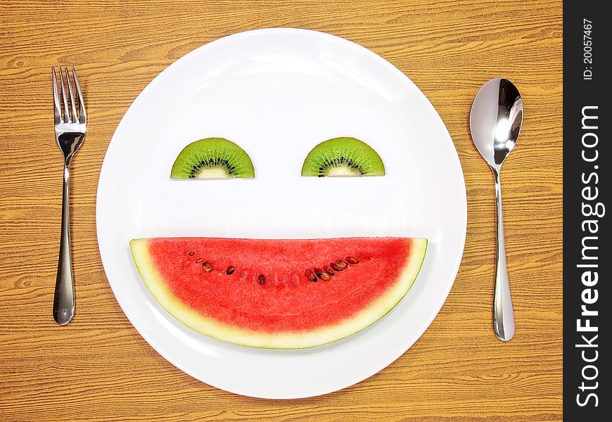 Smile watermelon and kiwi served on white plate. Smile watermelon and kiwi served on white plate