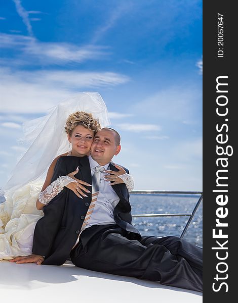 Happy bride and groom on a luxury yacht