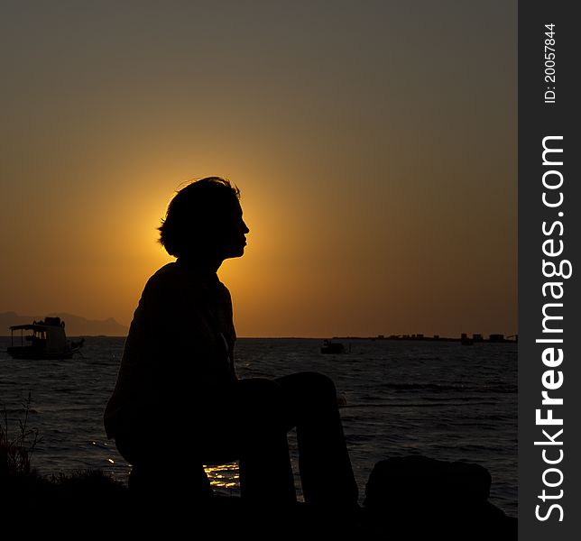 Silhouette of a young woman by the sea. Silhouette of a young woman by the sea