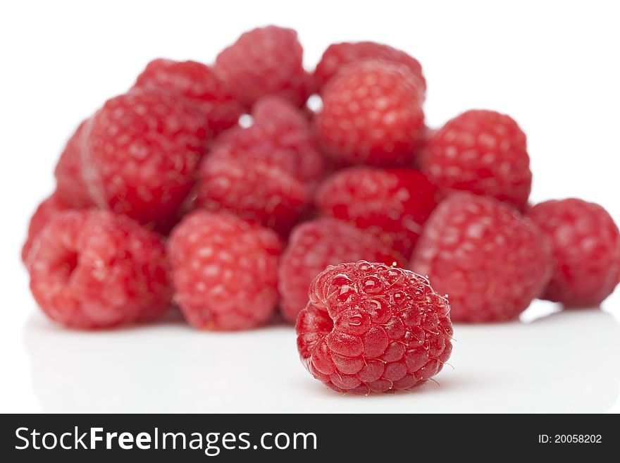 Fresh red raspberries against a white background