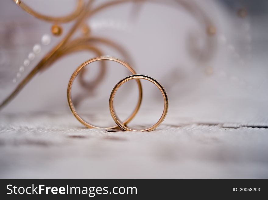 Wedding rings against a glass removed close up