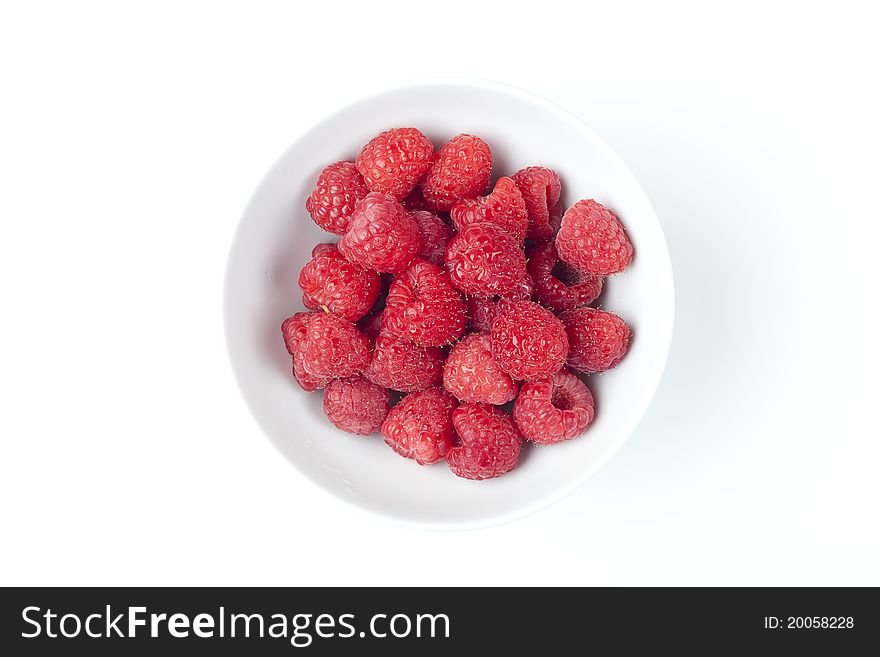 Fresh red raspberries against a white background