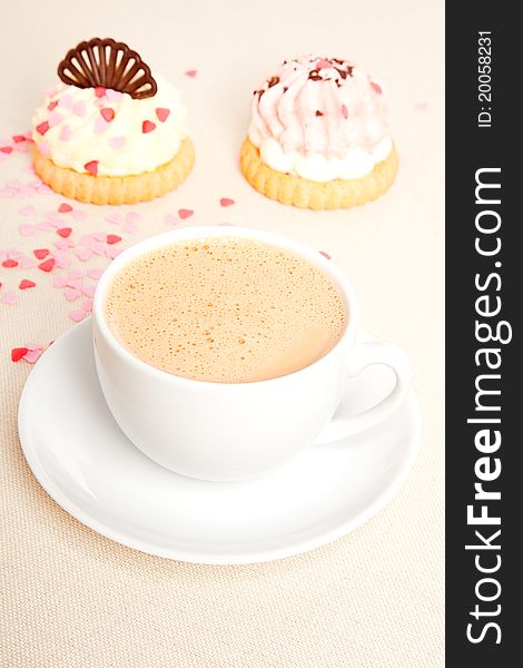 Cup coffee with cake on tablecloth