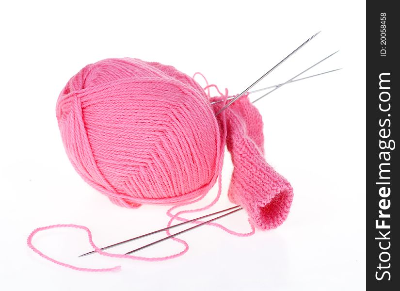 Ball of pink thread and knitting spokes. Ball of pink thread and knitting spokes