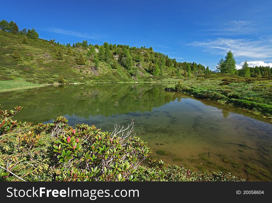 A small mountain lake at 2200 meters on the sea-level near Piz-Tri Peak, Brixia province, Lombardy region, Italy