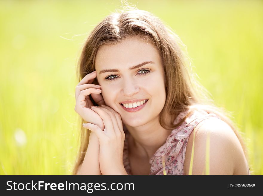 Beautiful happy young woman  in the park  on a warm summer day. Beautiful happy young woman  in the park  on a warm summer day