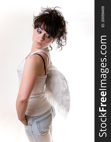 Young girls on white background looks astonishingly on her angel wings. Young girls on white background looks astonishingly on her angel wings