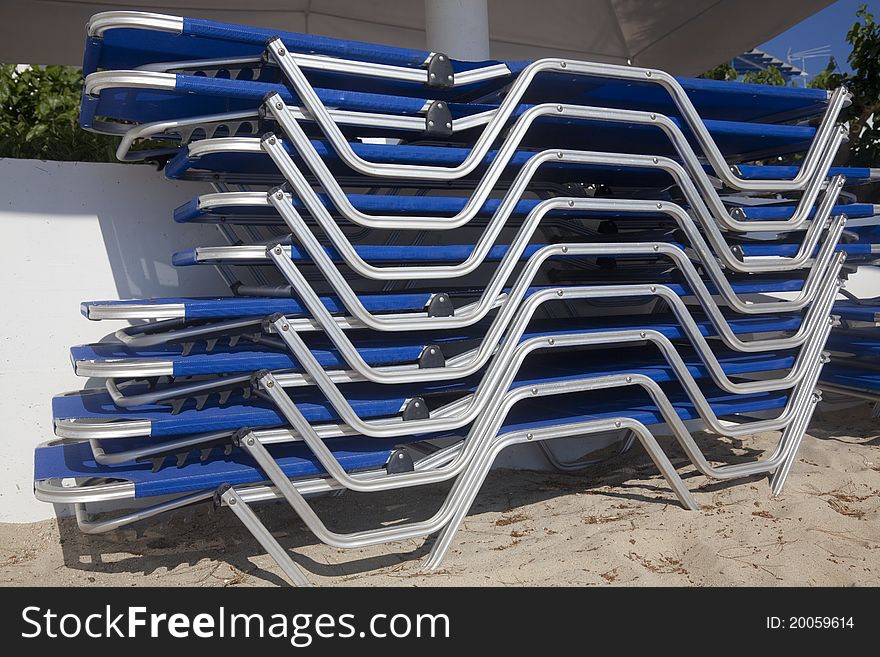 Stacked loungers on the beach