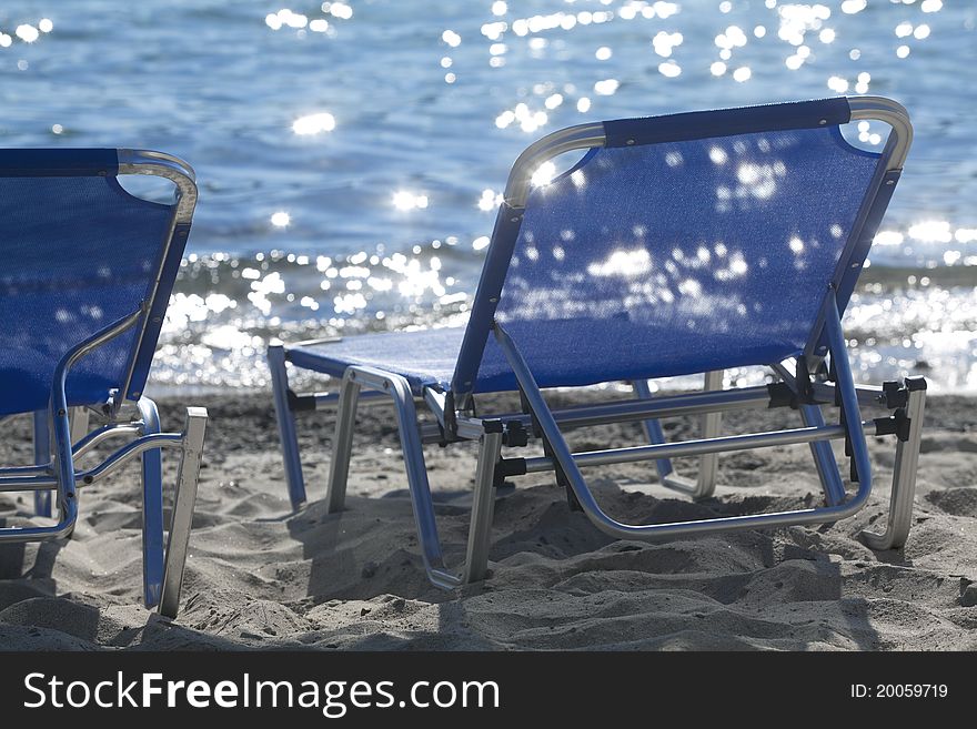 Blue loungers on the beach