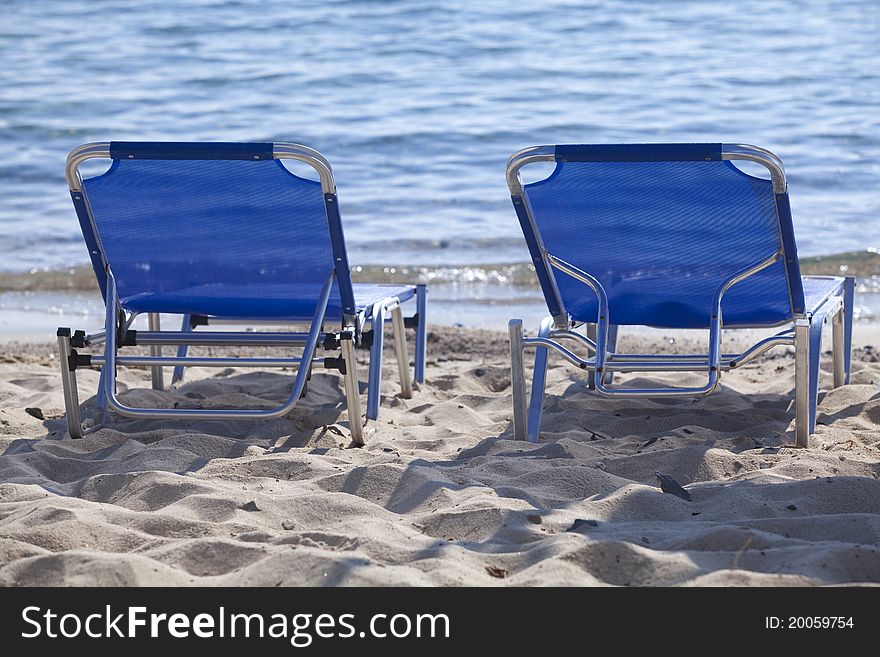 Blue loungers on the beach