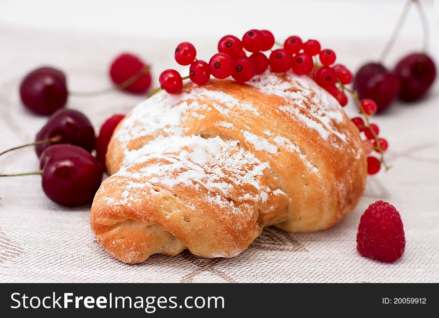 Croissant dusted with icing sugar and fresh berries. Croissant dusted with icing sugar and fresh berries