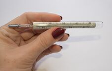 A Woman`s Hand Holds A Mercury Thermometer For Measuring Body Temperature Stock Photography A Woman`s Hand Holds A Mercury Thermometer For Measuring Body Temperature Stock Photography