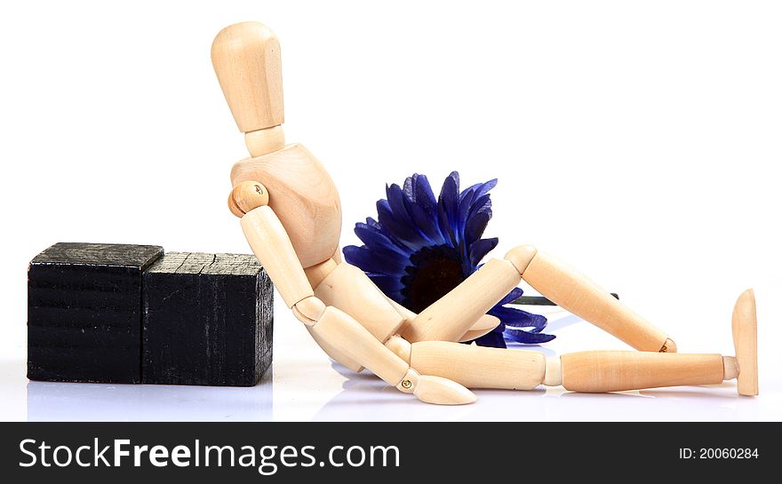 Wooden mannequin sitting and dreaming over white background. Wooden mannequin sitting and dreaming over white background.