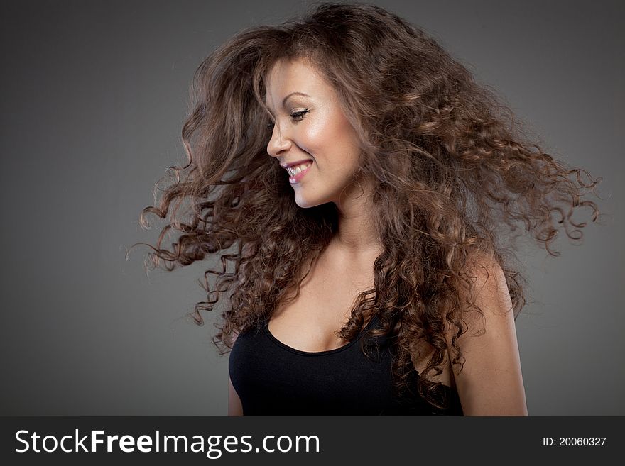 Portrait of smiling woman with curly hair