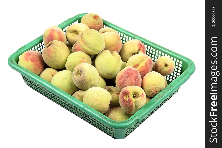 Ripe apricots in plastic basket isolated on white background.