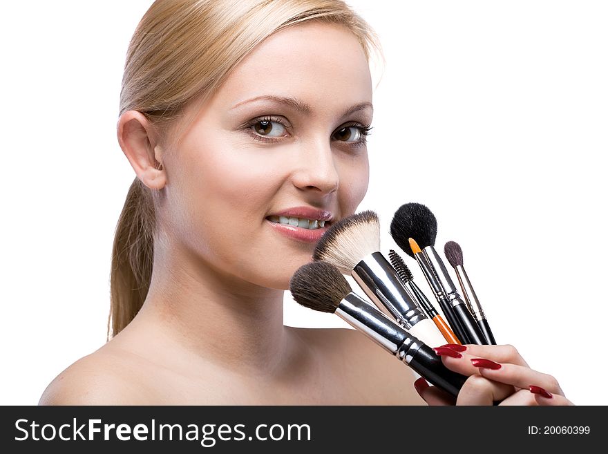 Young smiling woman with make up brushes isolated on white