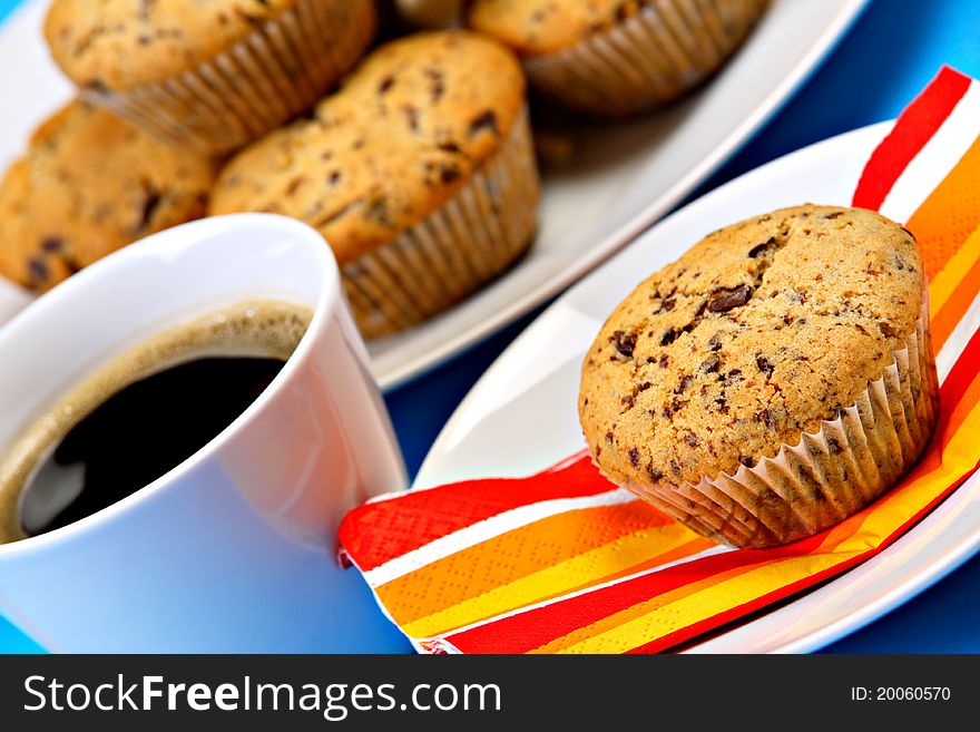 Cup of fresh coffee with chocolate chip muffins. Cup of fresh coffee with chocolate chip muffins