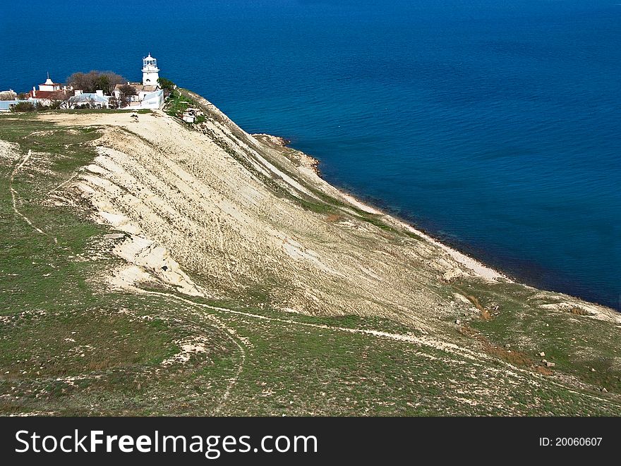 Old white lighthouse on sea coast