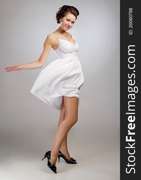 Moving dancing in dress on gray background. Moving dancing in dress on gray background