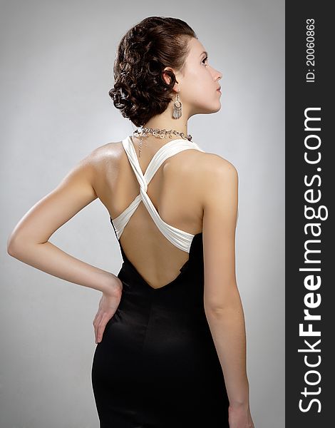 In dress with naked back decollete and bijouterie beads. In dress with naked back decollete and bijouterie beads