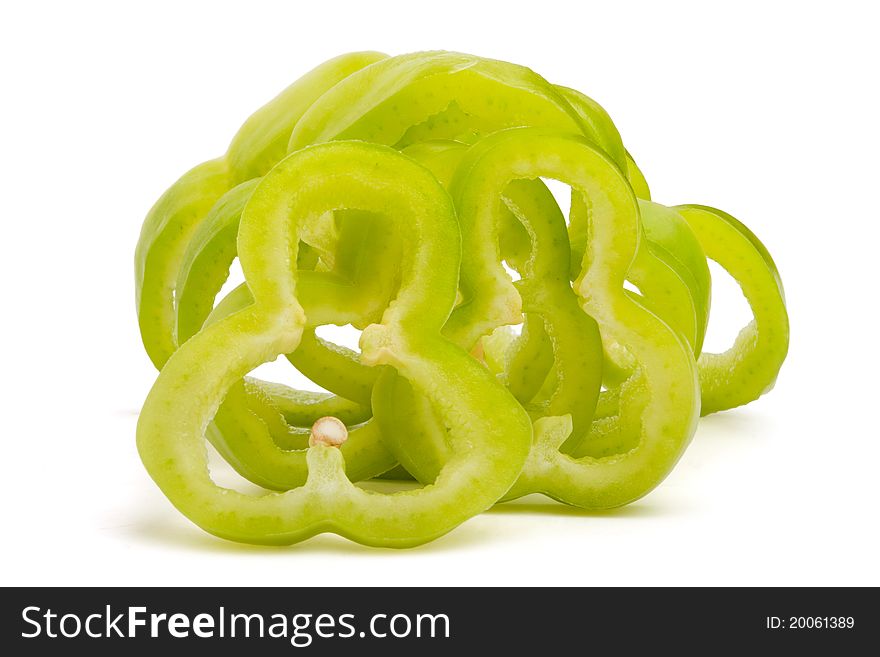 Cut green bell-pepper on white