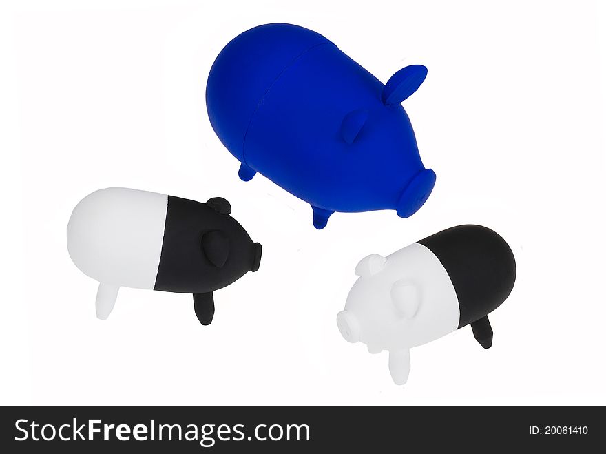 Three toy pigs isolated on white background