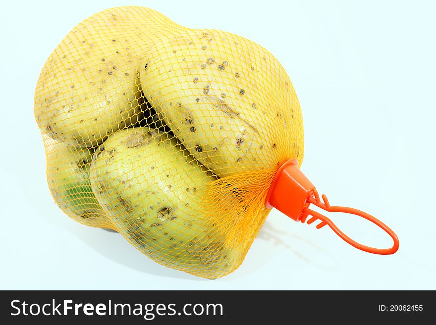 Yellow potatoes in a bag net.
