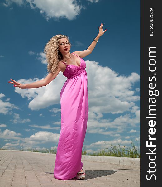 Attractive woman in a pink dress