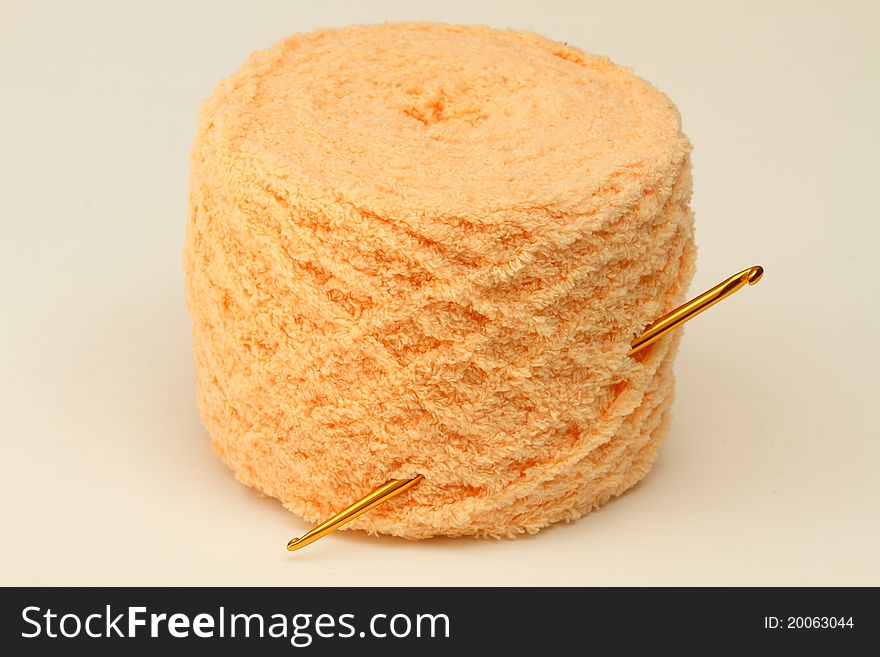 Yarn and crochet needle isolated on white background
