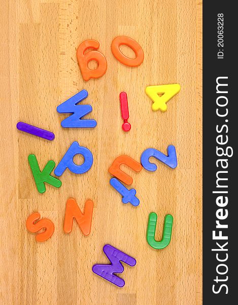 Play letters scattered over a wooden floor