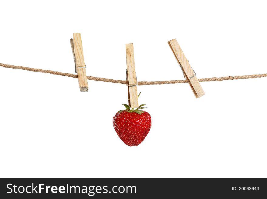 Lonely strawberry attached to a clothesline with pin isolated on white background. Lonely strawberry attached to a clothesline with pin isolated on white background