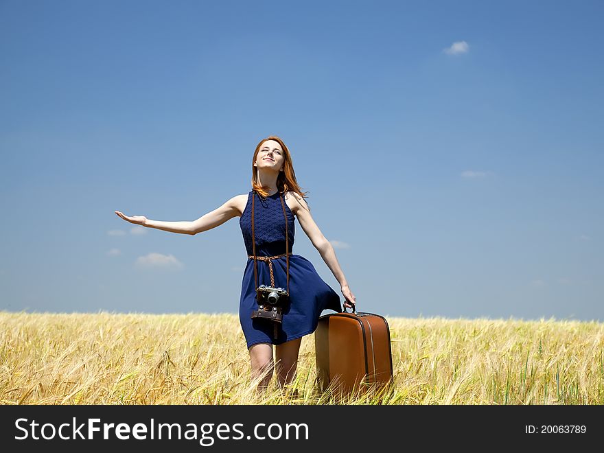 Girl With Suitcase At Spring Wheat Field.