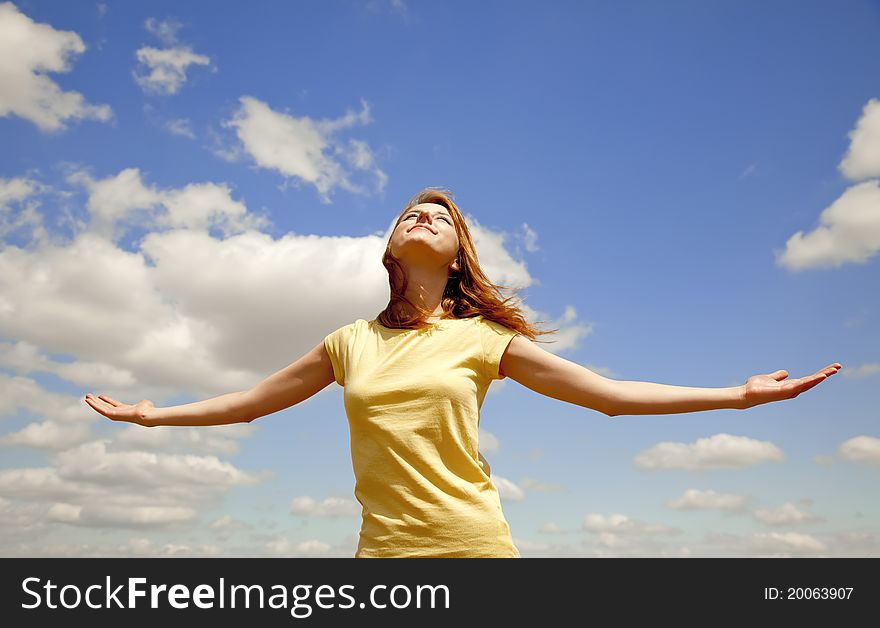 Girl at blue sky background. Outdoor photo.