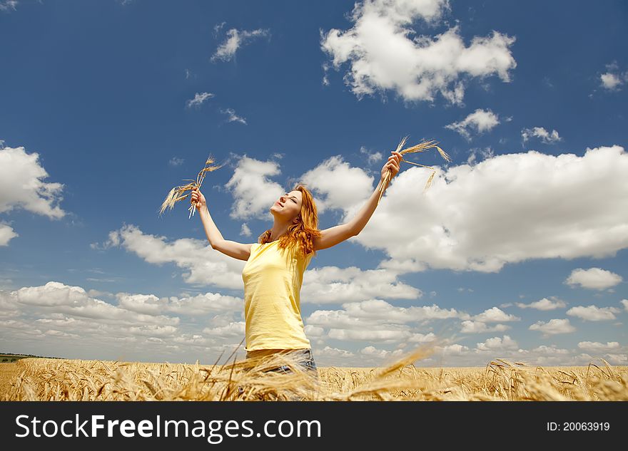 Girl at wheat field at summertime. Outdoor photo.