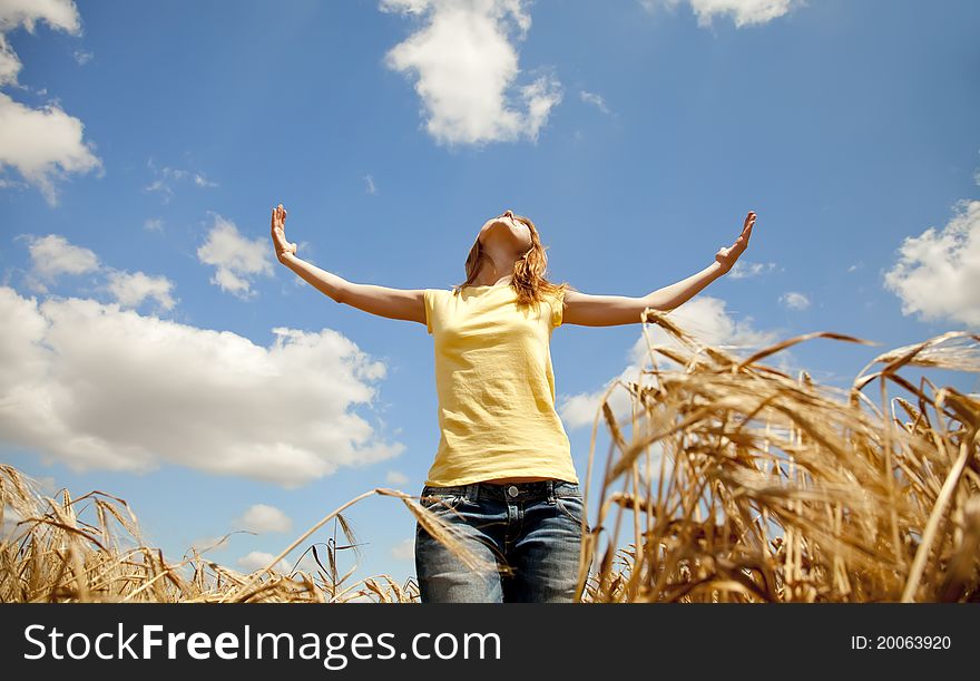 Girl At Wheat Field At Summertime.