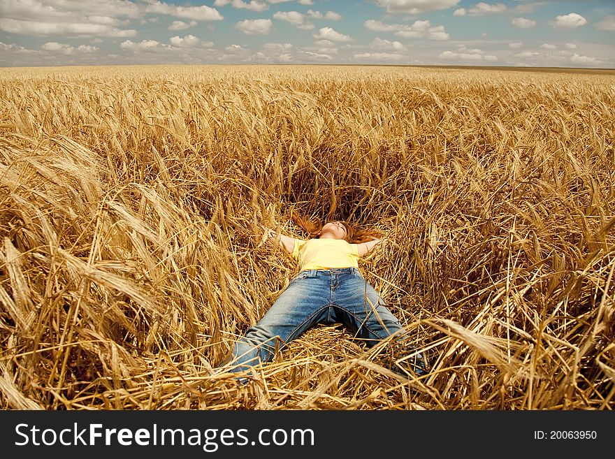 Girl Sleeping At Wheat Field At Summertime.