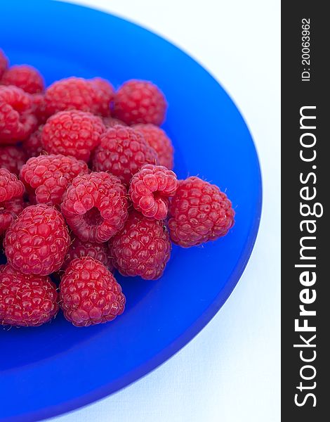 Delicious raspberries on the blue plate. Delicious raspberries on the blue plate