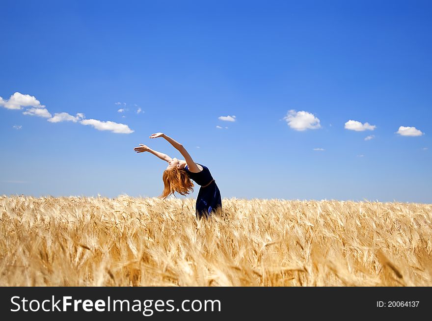 Girl At Wheat Field In Summer Day.