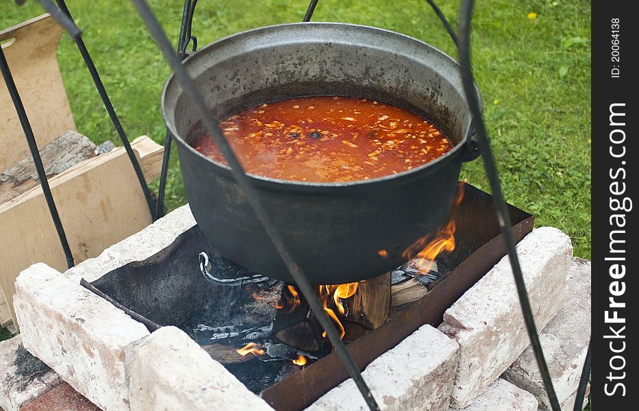 Cooking of soup in the pot on fire. Cooking of soup in the pot on fire