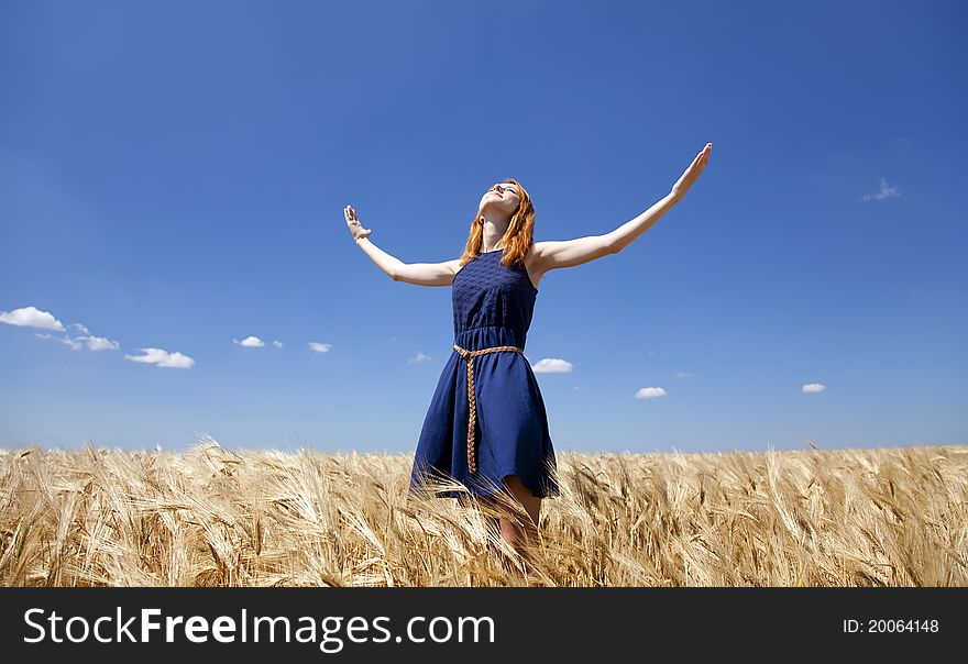 Girl At Wheat Field In Summer Day.