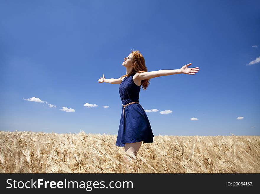 Girl At Wheat Field In Summer Day.