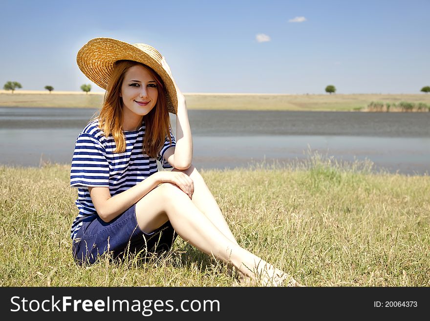 Redhead girl at countryside nead lake.