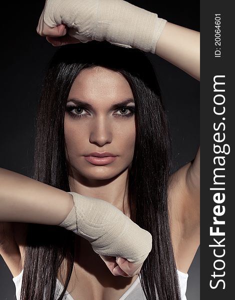 Beautiful woman boxer portrait wearing bandage on hands