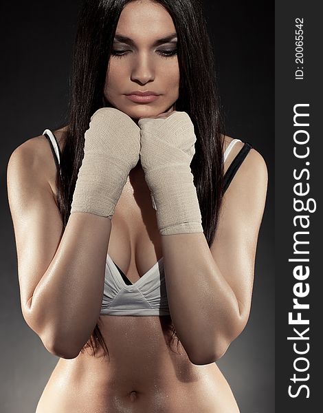 Beautiful woman boxer portrait wearing bandage on hands