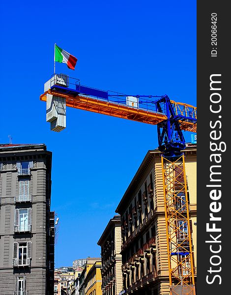 Lifting faucet and the italian flag on a background sky