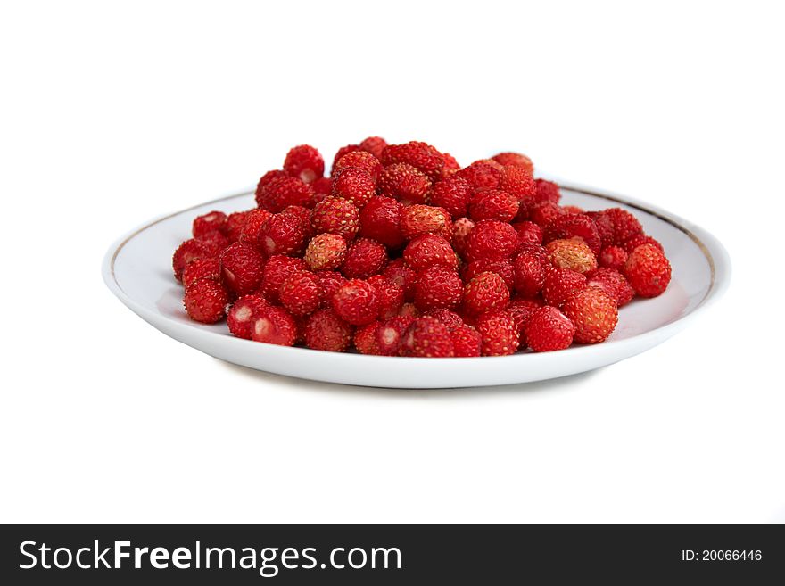 Plate full of wild strawberries isolated on white