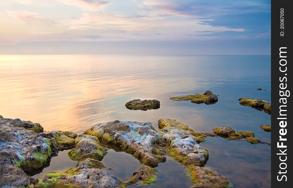 Sea and rock at the sunset.