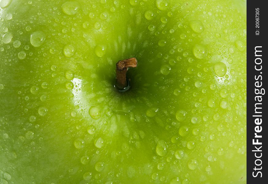 Green apple with water drops  as background