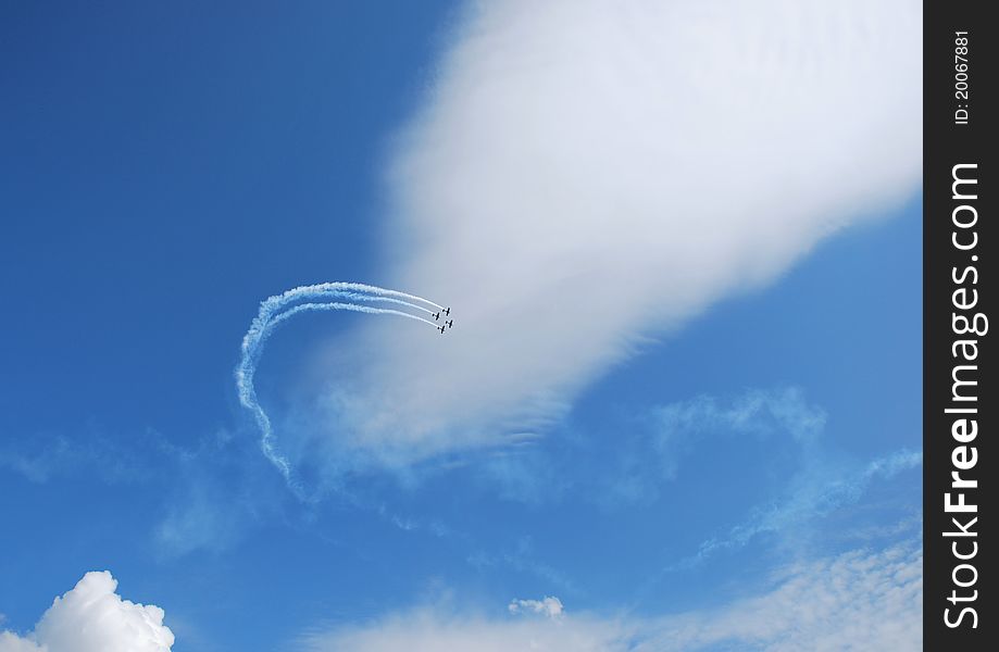 Fly aircraft on a flight show a winding, beautiful blue sky. Fly aircraft on a flight show a winding, beautiful blue sky