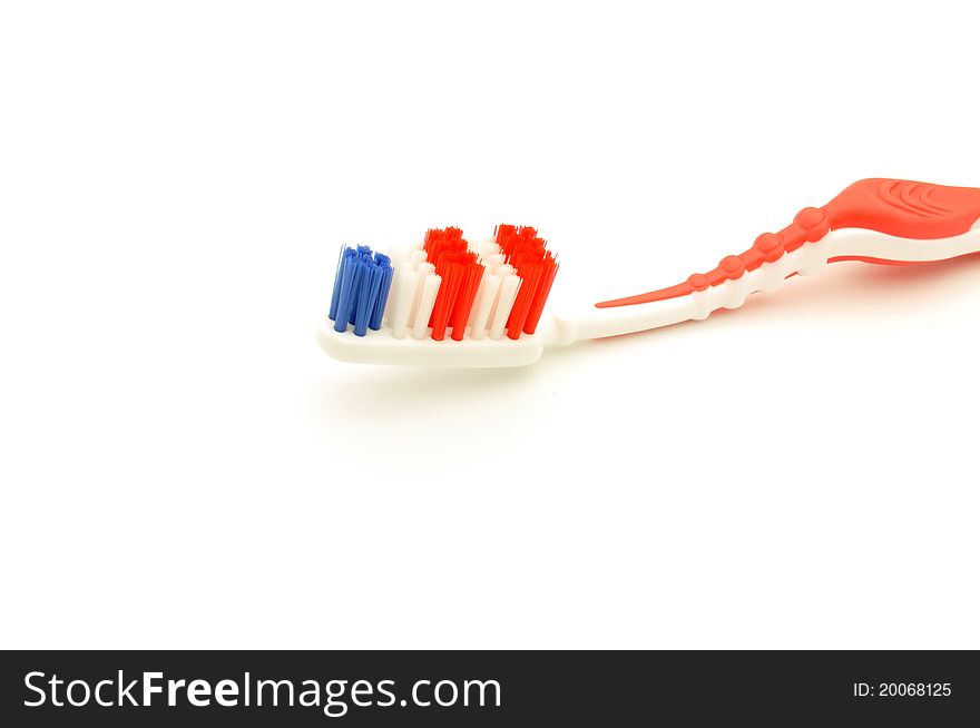 Close-up colorful toothbrush on a white background. Close-up colorful toothbrush on a white background